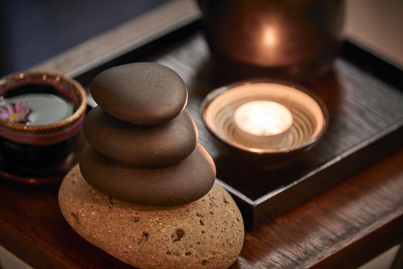 Parnas Hotel Jeju Seogwipo Exterior photo A candle and some stones